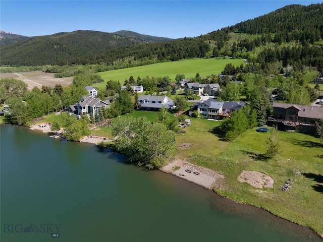 drone / aerial view featuring a water and mountain view