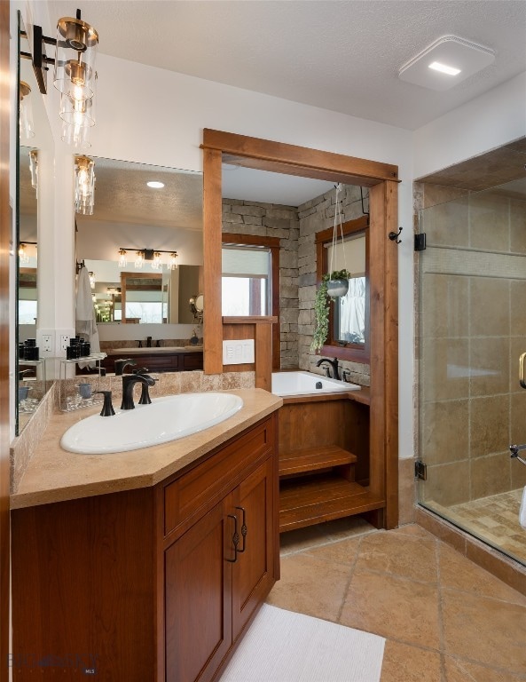 bathroom with vanity and independent shower and bath