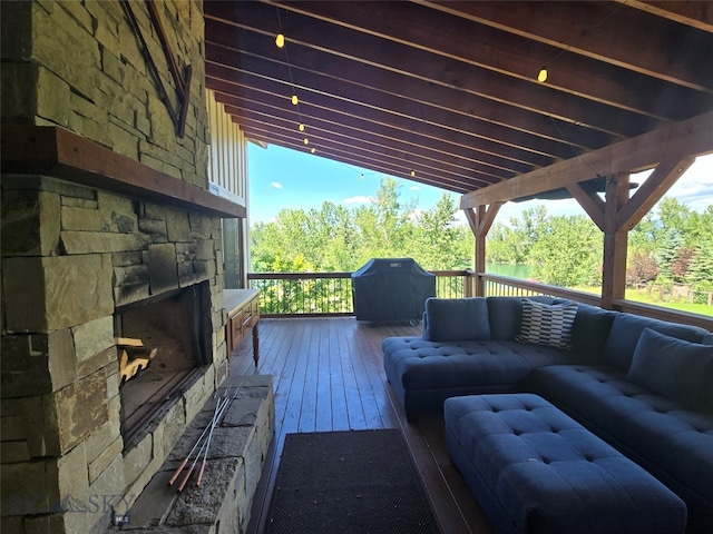 deck featuring an outdoor living space with a fireplace and grilling area