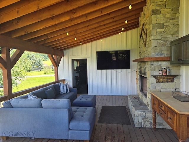 wooden terrace with an outdoor hangout area