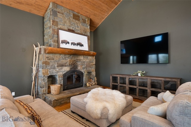 living room with hardwood / wood-style floors, a wood stove, lofted ceiling, and wood ceiling