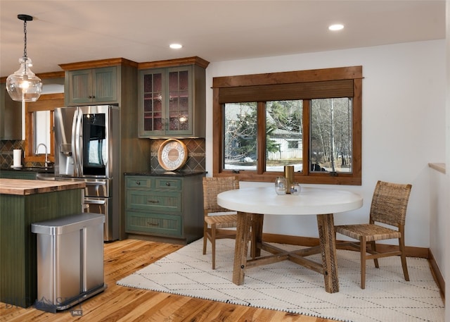 dining room with light hardwood / wood-style floors and sink