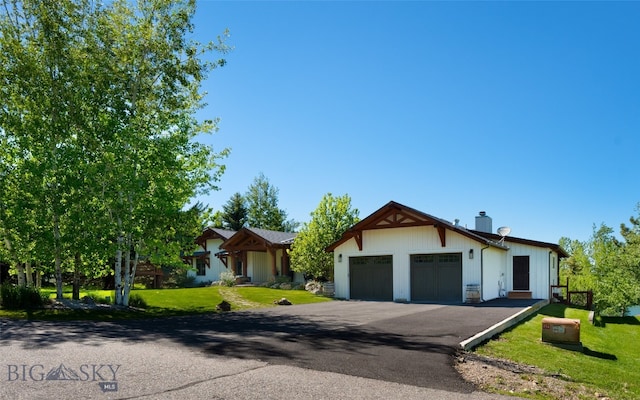 view of front of house featuring a garage and a front lawn