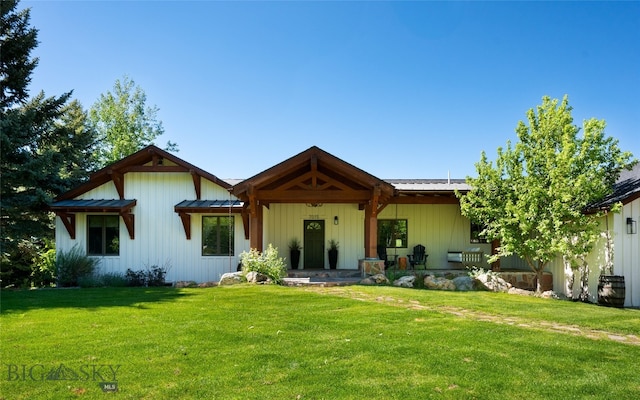 back of house with a lawn and a porch