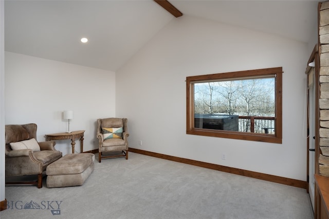 living area featuring beam ceiling, light colored carpet, and high vaulted ceiling