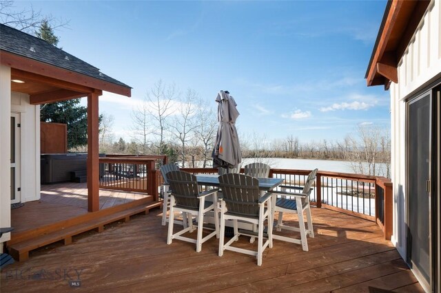 snow covered deck featuring a hot tub