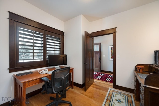 office with light hardwood / wood-style flooring