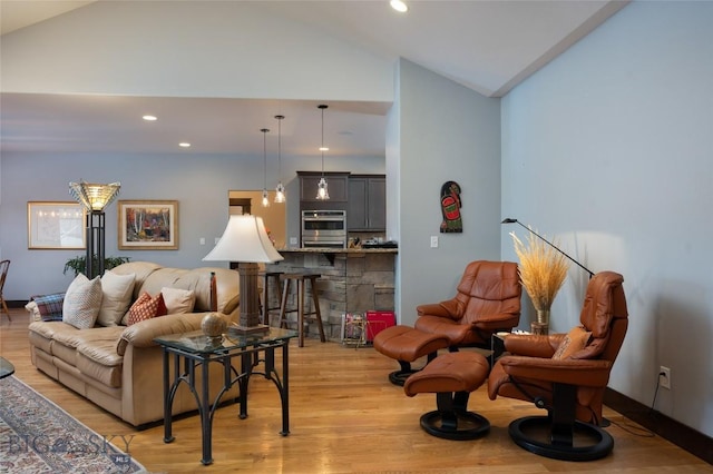 living room with lofted ceiling and light hardwood / wood-style floors