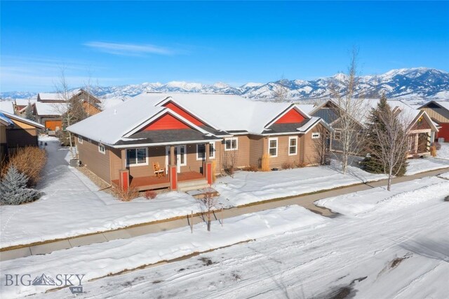 view of front of home with a porch and a mountain view