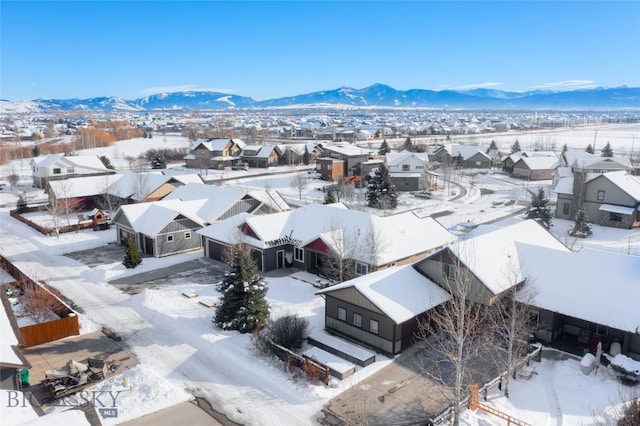 snowy aerial view with a mountain view