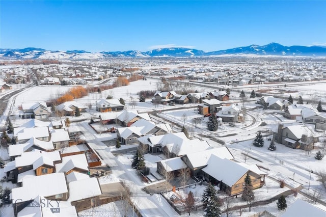 snowy aerial view featuring a mountain view