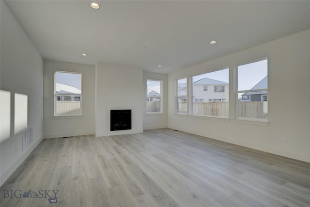 unfurnished living room featuring light hardwood / wood-style flooring