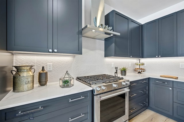 kitchen with decorative backsplash, light hardwood / wood-style floors, high end stainless steel range, and wall chimney exhaust hood