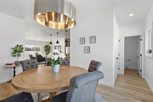 dining space with light hardwood / wood-style floors