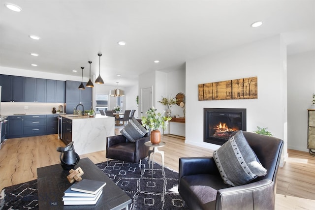 living room featuring light hardwood / wood-style floors and sink