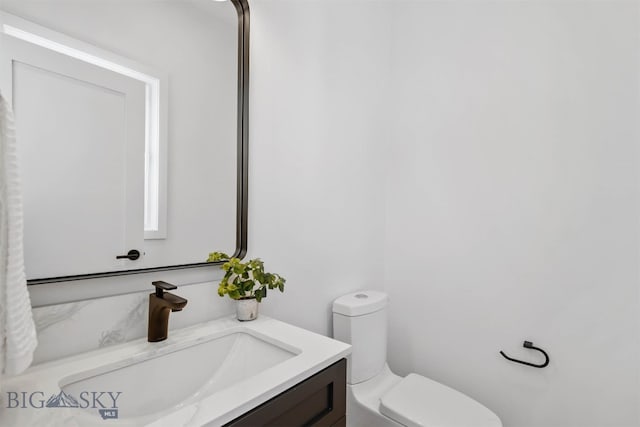 bathroom featuring vanity and toilet