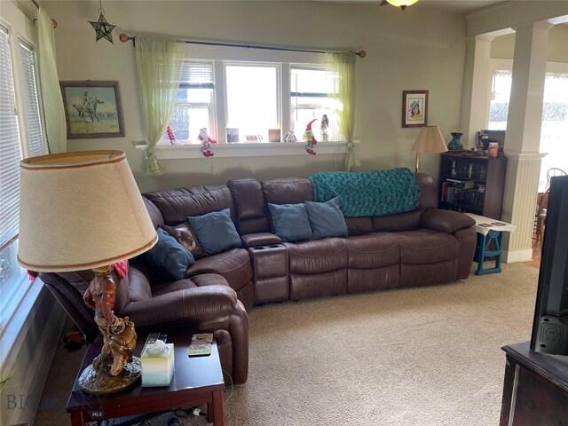 carpeted living room featuring decorative columns