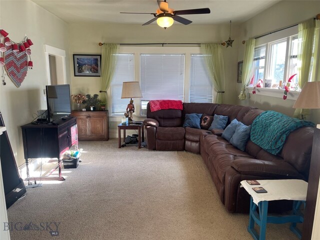 carpeted living room featuring ceiling fan