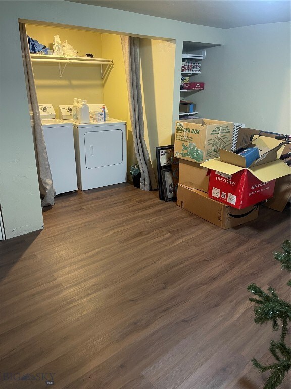 laundry room featuring washing machine and dryer and wood-type flooring