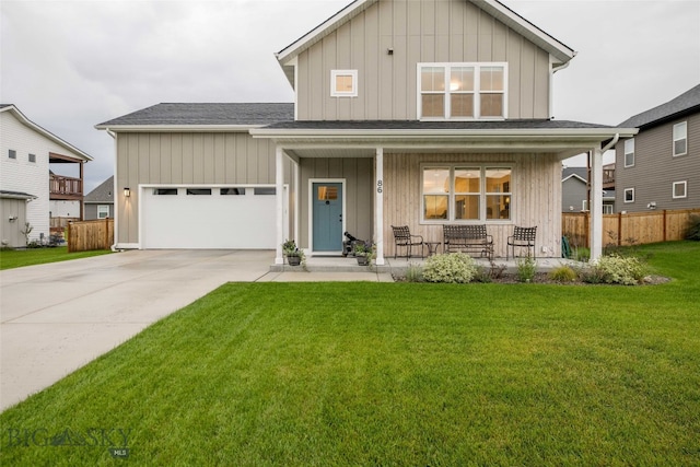 view of front facade featuring a garage, covered porch, and a front yard