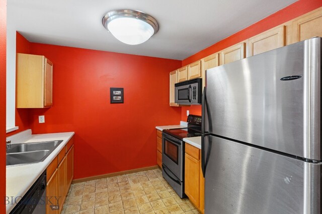 kitchen featuring light brown cabinets, sink, and appliances with stainless steel finishes