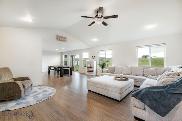 living room with hardwood / wood-style floors, ceiling fan, and lofted ceiling