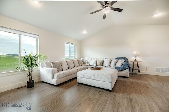 living room with ceiling fan, lofted ceiling, and hardwood / wood-style flooring