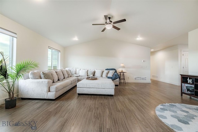 living room with hardwood / wood-style flooring, ceiling fan, and lofted ceiling