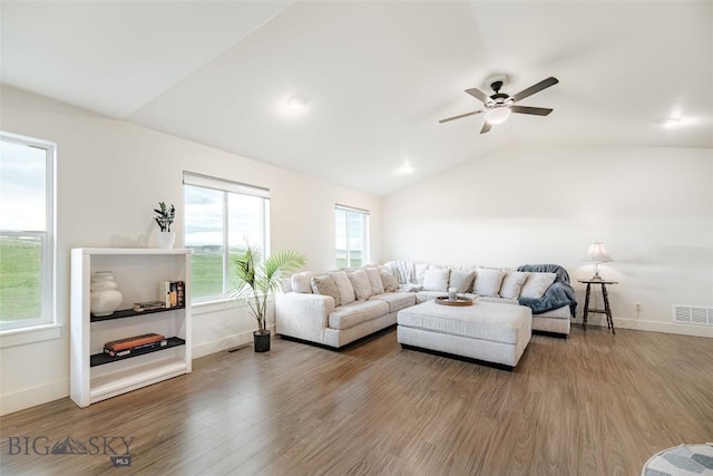 living room featuring hardwood / wood-style flooring, ceiling fan, a healthy amount of sunlight, and vaulted ceiling