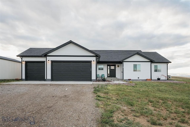 ranch-style home featuring a garage and a front lawn