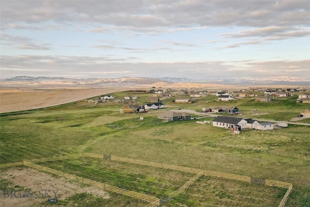 aerial view at dusk with a mountain view and a rural view