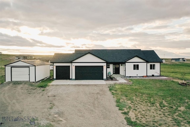 ranch-style home featuring an outdoor structure and a front yard