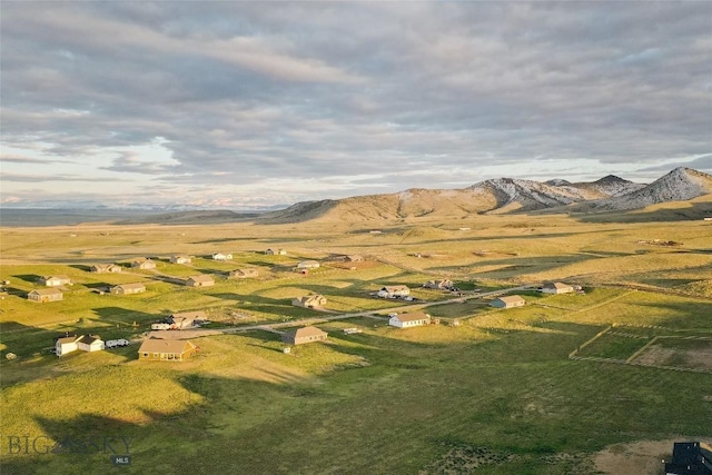 birds eye view of property with a mountain view and a rural view