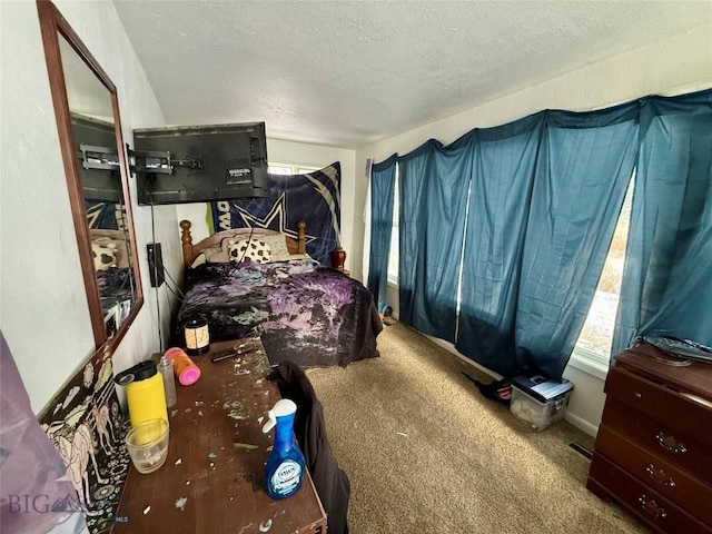 carpeted bedroom featuring a textured ceiling