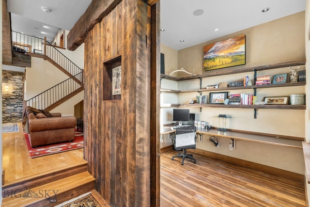 office featuring hardwood / wood-style floors and built in desk