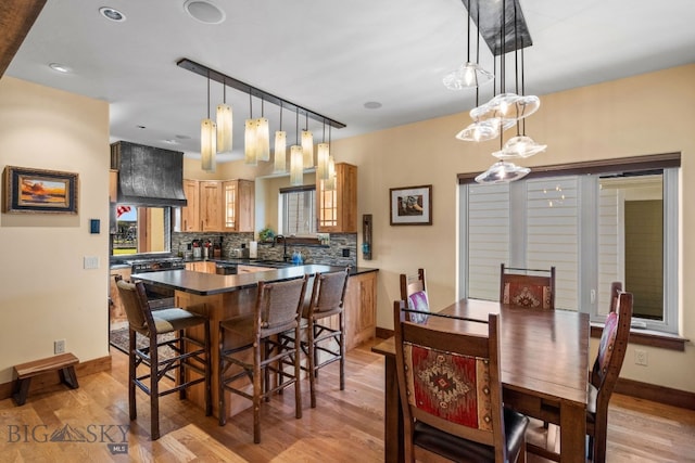 dining space with light wood-type flooring and sink