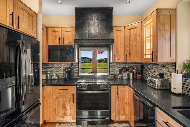 kitchen featuring backsplash, ventilation hood, and black appliances