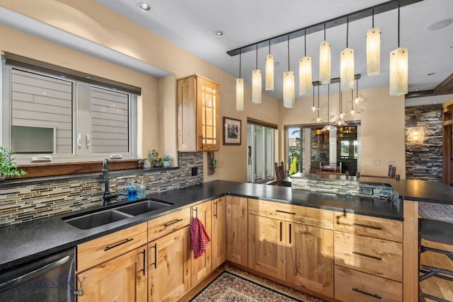 kitchen with dishwasher, backsplash, sink, hanging light fixtures, and kitchen peninsula