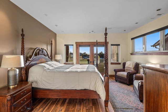 bedroom featuring french doors, dark wood-type flooring, and multiple windows