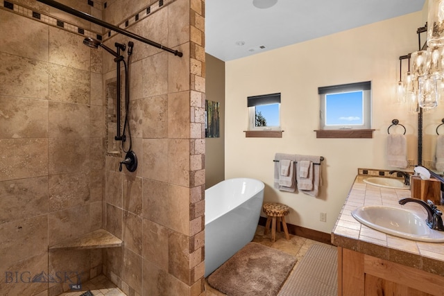 bathroom with tile patterned flooring, vanity, and separate shower and tub