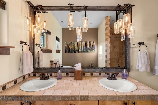 bathroom featuring a shower and vanity