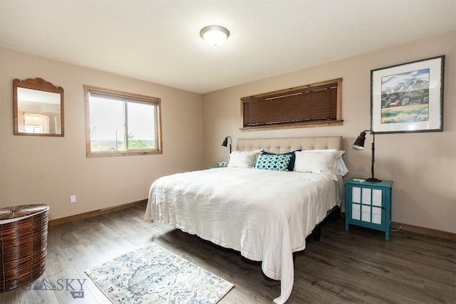 bedroom with dark hardwood / wood-style flooring