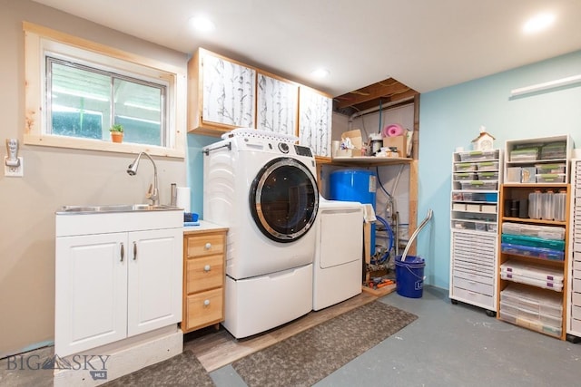 laundry room featuring washer and clothes dryer, cabinets, and sink