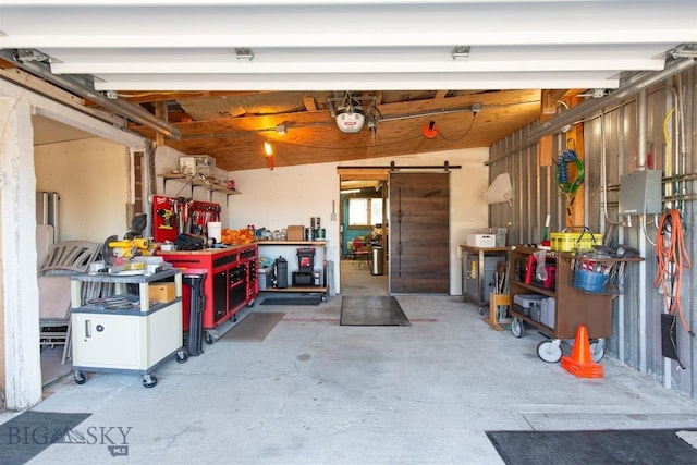 garage with a workshop area and a garage door opener