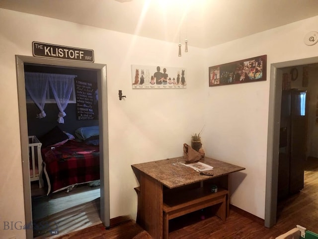 corridor with dark hardwood / wood-style flooring