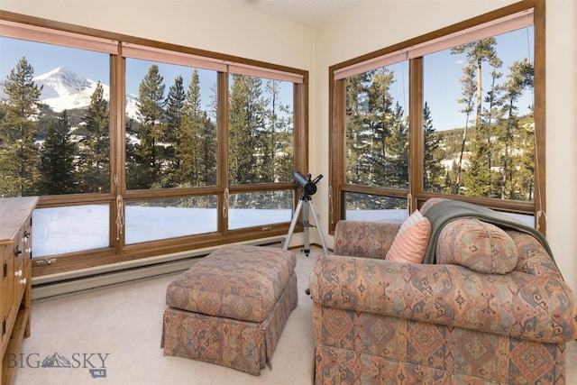 sunroom featuring a mountain view and a baseboard heating unit