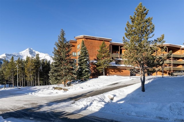 snow covered building featuring a mountain view