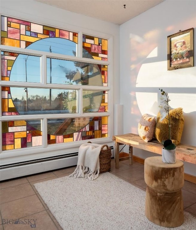 interior space with tile patterned floors and a baseboard heating unit