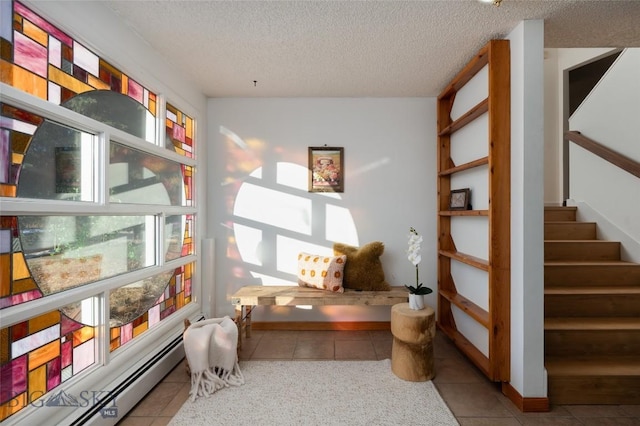 sitting room featuring a textured ceiling, a baseboard radiator, and light tile patterned flooring