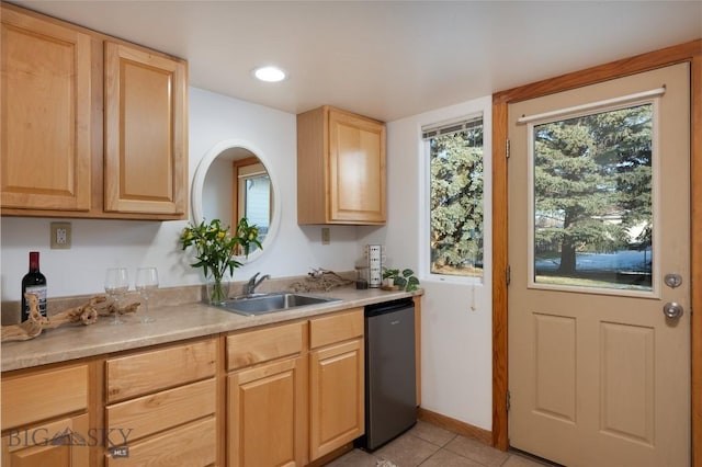 kitchen with dishwasher, light brown cabinets, light tile patterned floors, and sink